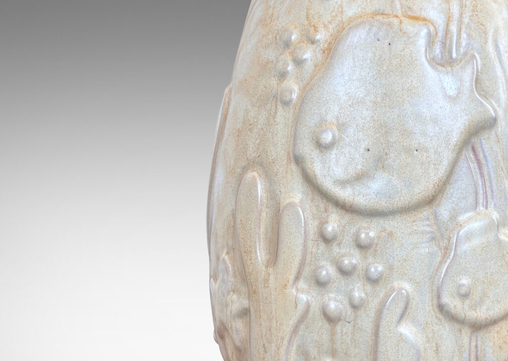 Gallery BACupward tapering ovoid form with playful reliefs of marine flora and fauna, glazed in sandy pale yellow