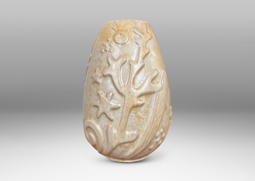 Gallery BACupward tapering ovoid form with playful reliefs of marine flora and fauna, glazed in sandy pale yellow