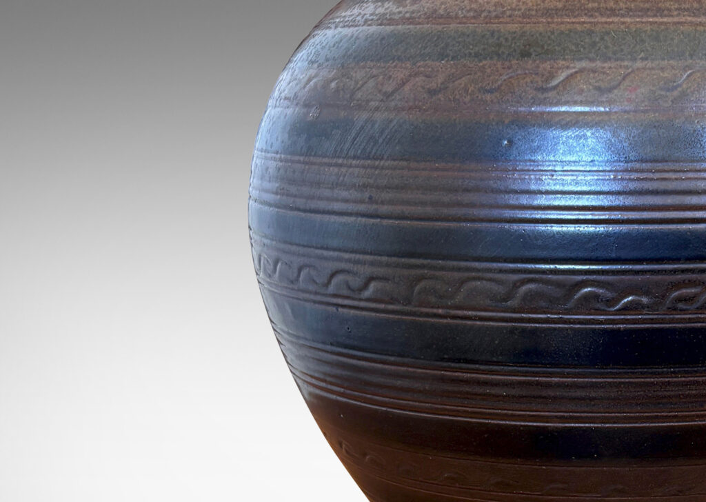 Gallery BAC tapered globe form with carved horizontal registers of alternating patterns, glazed in deep brown-black