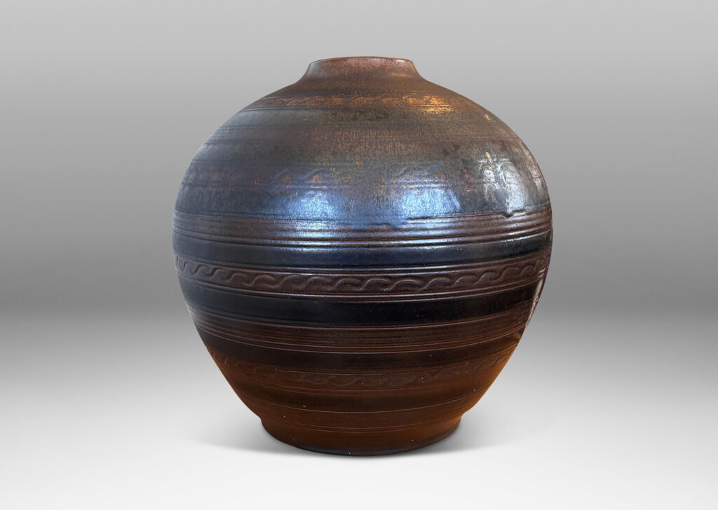 Gallery BAC tapered globe form with carved horizontal registers of alternating patterns, glazed in deep brown-black