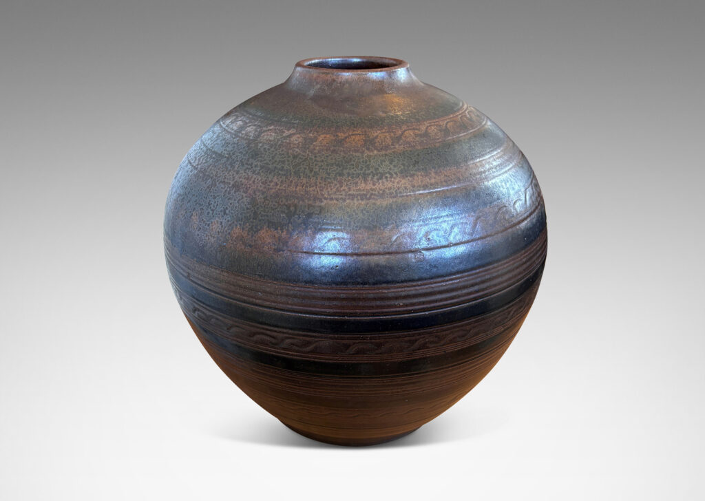 Gallery BAC tapered globe form with carved horizontal registers of alternating patterns, glazed in deep brown-black