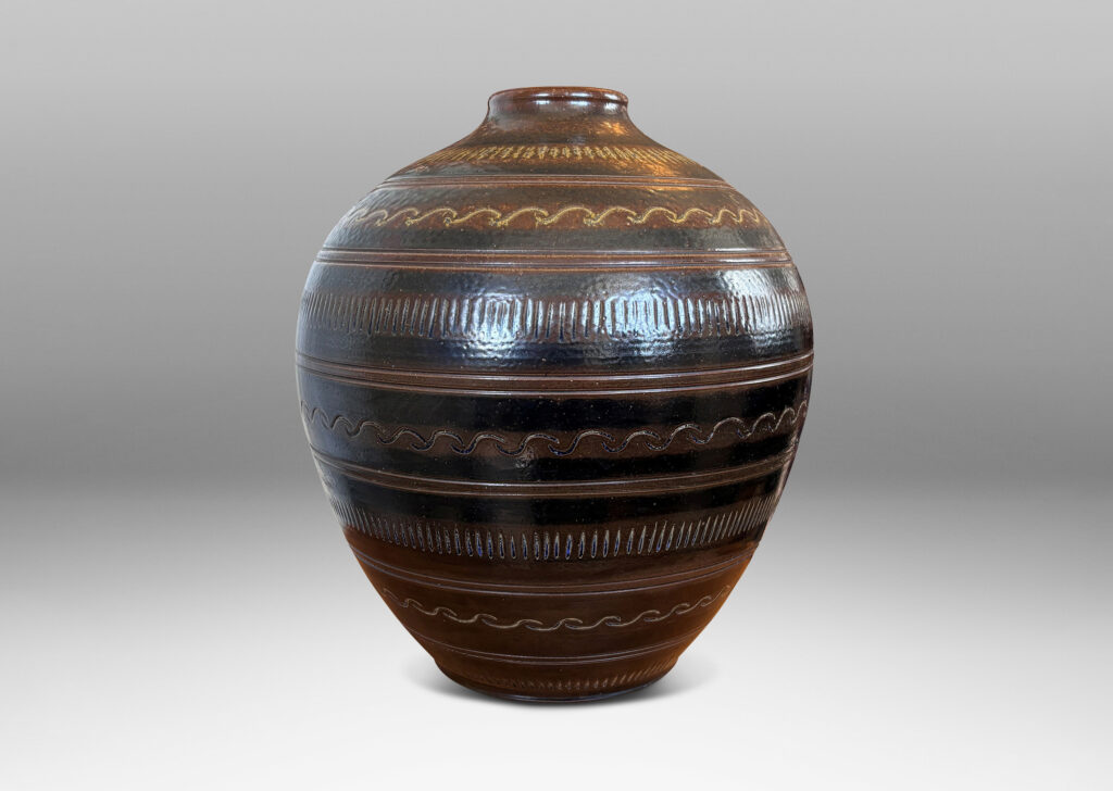 Gallery BAC tapered ovoid form with carved horizontal registers of alternating patterns, glazed in deep brown-black