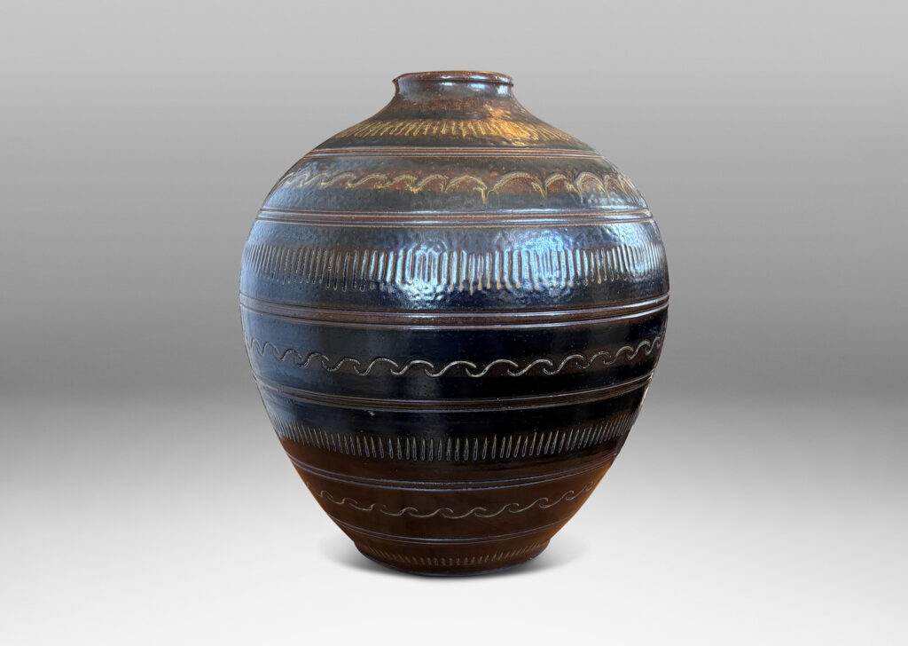 Gallery BAC tapered ovoid form with carved horizontal registers of alternating patterns, glazed in deep brown-black