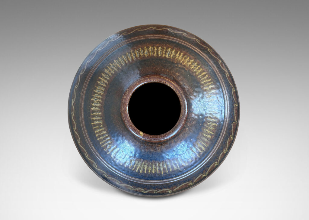 Gallery BAC tapered ovoid form with carved horizontal registers of alternating patterns, glazed in deep brown-black