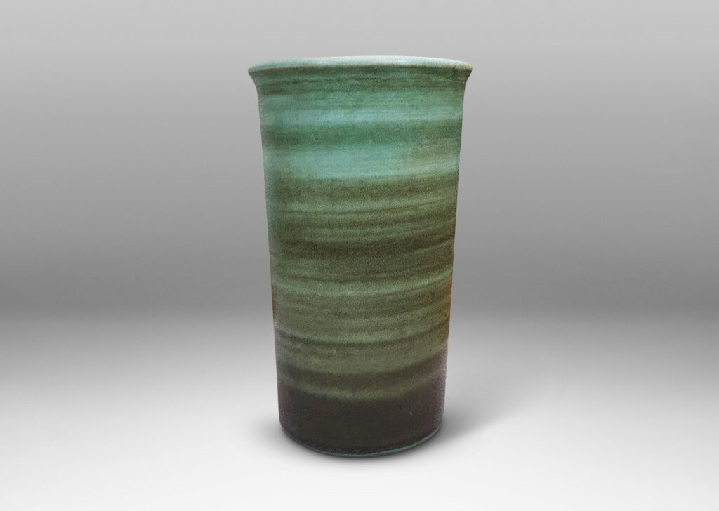 Gallery BAC cylindrical form with gently flared lip, striae glazed in evergreen and jade green tones, with a pale gray interior