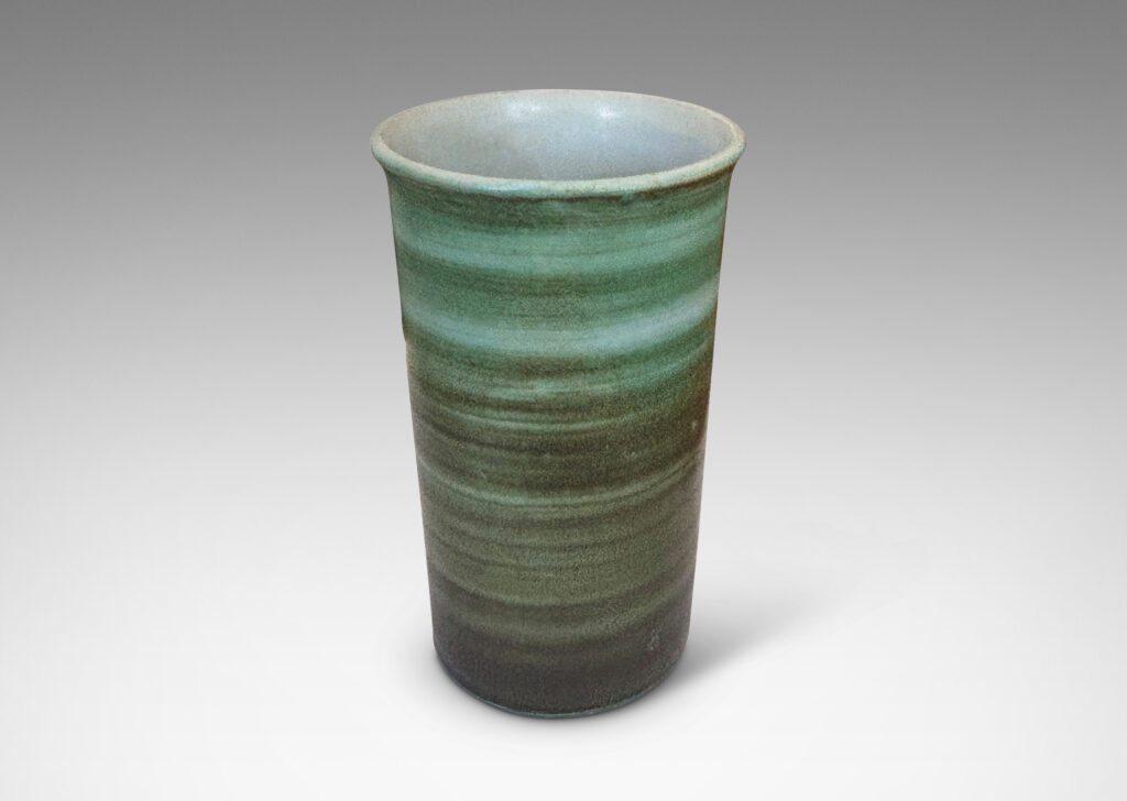 Gallery BAC cylindrical form with gently flared lip, striae glazed in evergreen and jade green tones, with a pale gray interior
