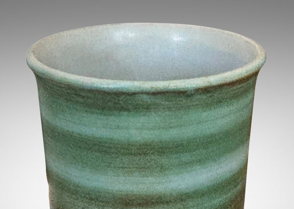 Gallery BAC cylindrical form with gently flared lip, striae glazed in evergreen and jade green tones, with a pale gray interior