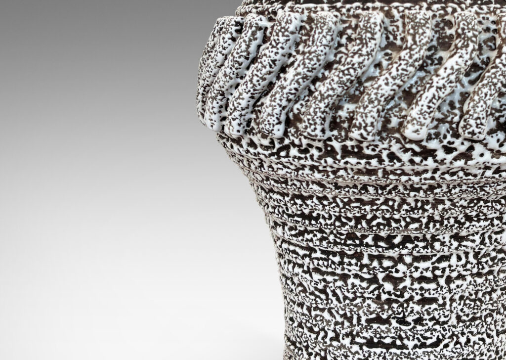 Gallery BAC arge ridged ballooning form, with relief “piecrust” band and circle of applied S-forms, glazed in a white “crispé” layer over matte brown