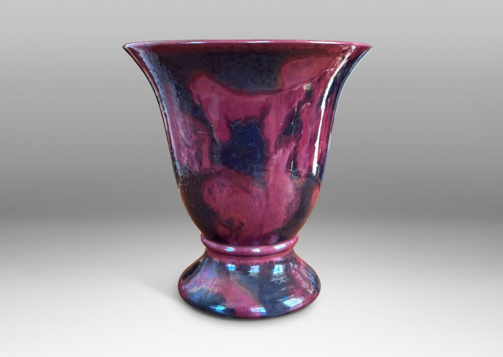Gallery BAC lared bell form on a flanged base, moodily glazed in charcoal gray and red luster