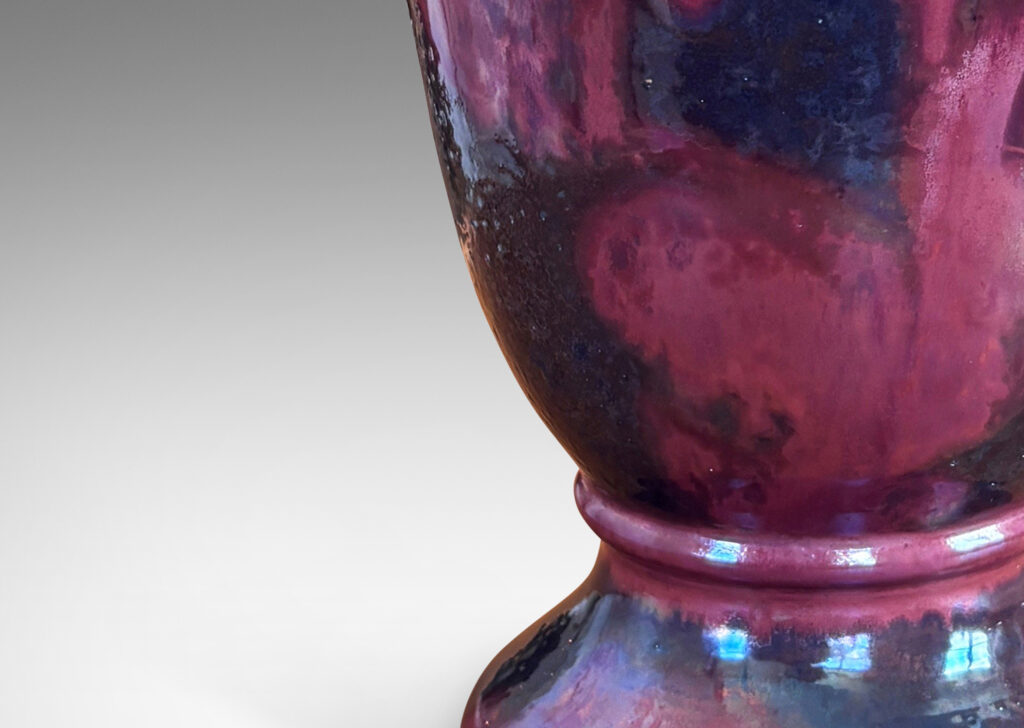 Gallery BAC lared bell form on a flanged base, moodily glazed in charcoal gray and red luster