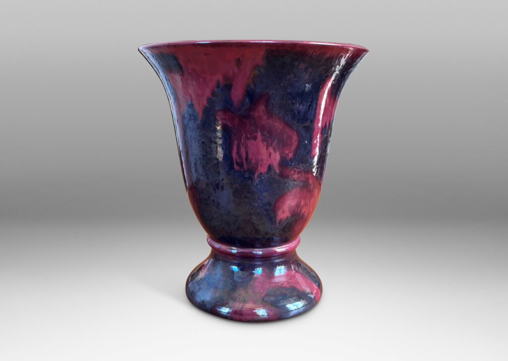 Gallery BAC lared bell form on a flanged base, moodily glazed in charcoal gray and red luster