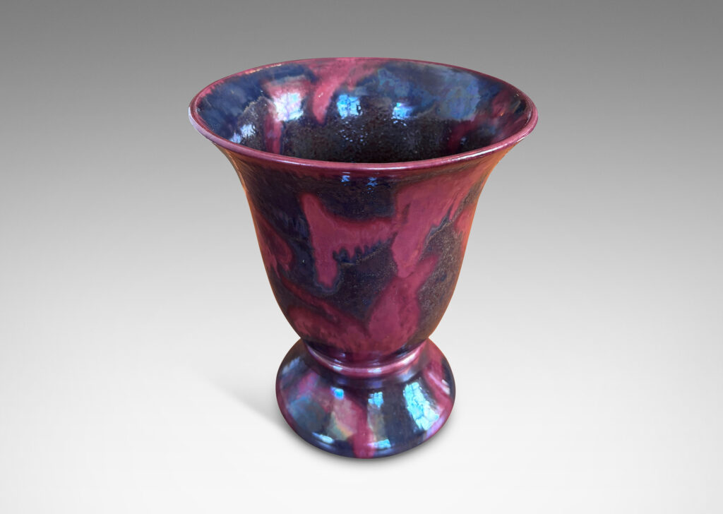 Gallery BAC lared bell form on a flanged base, moodily glazed in charcoal gray and red luster