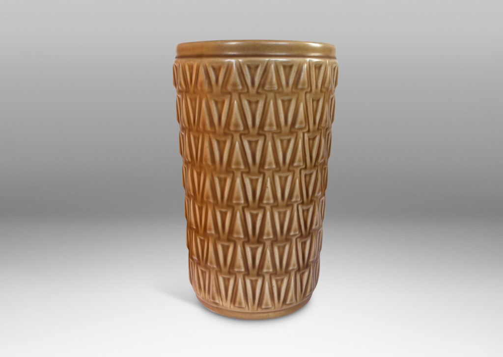 Gallery BAC tapered cylindrical forms patterned with rows of relief triangles, glazed tan