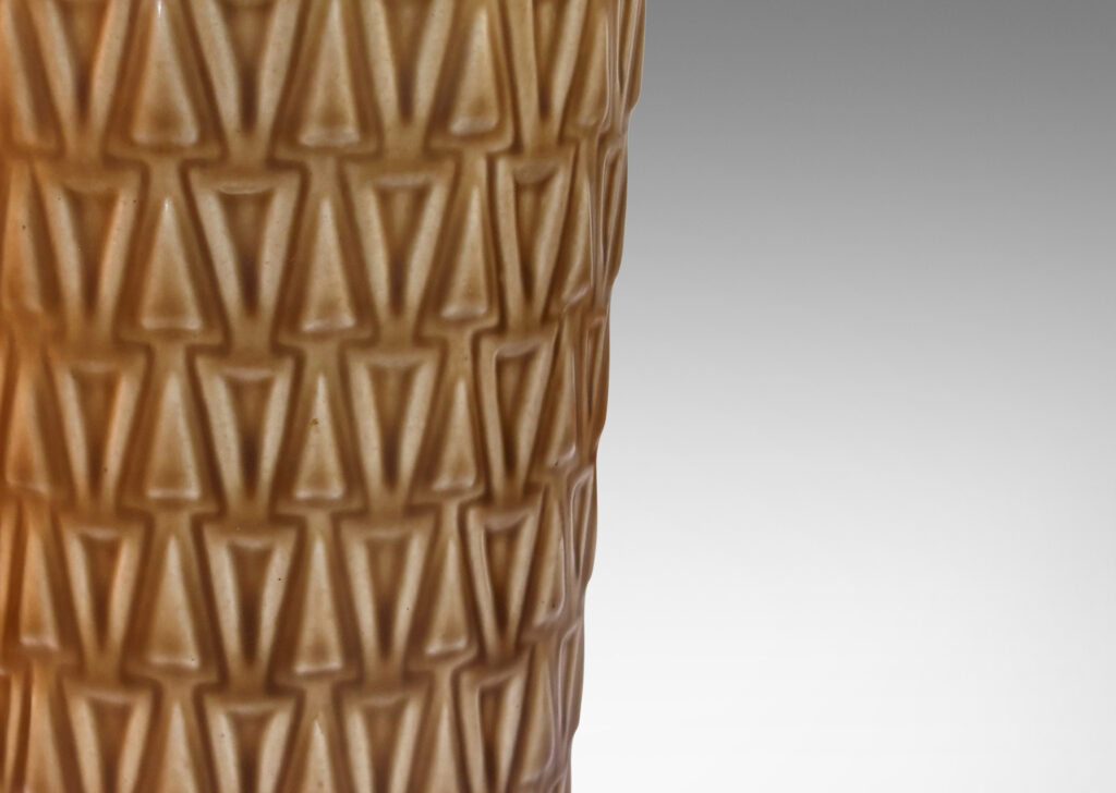 Gallery BAC tapered cylindrical forms patterned with rows of relief triangles, glazed tan