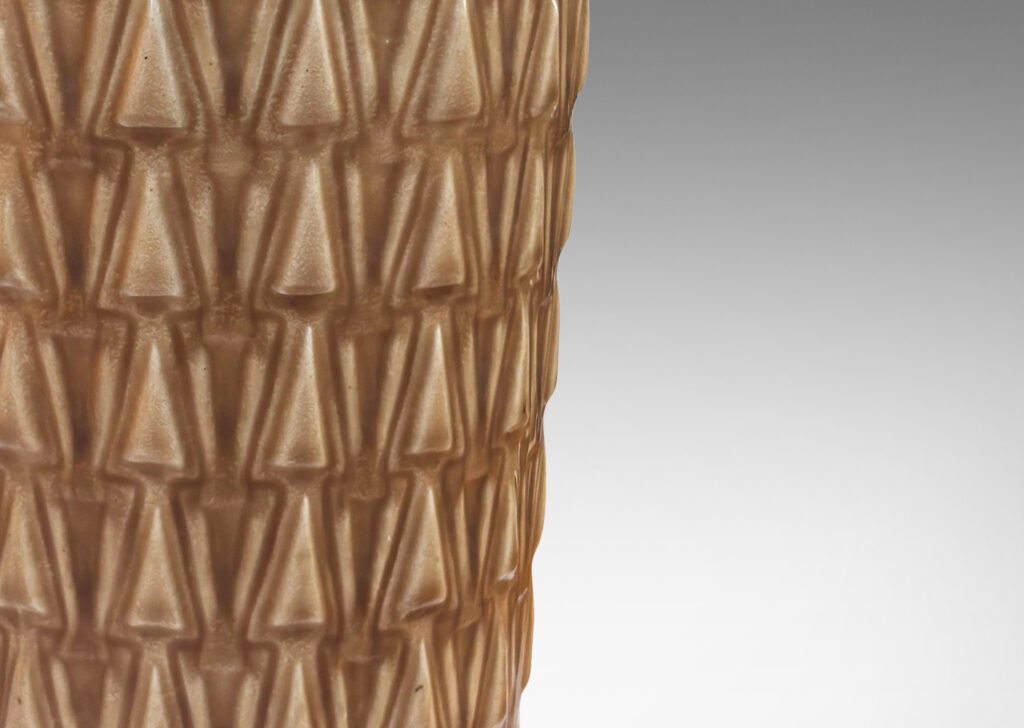 Gallery BAC tapered cylindrical forms patterned with rows of relief triangles, glazed tan