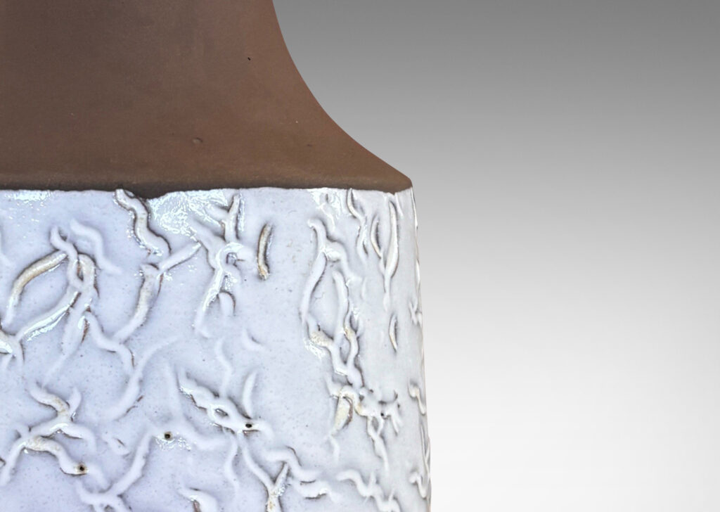 Gallery BAC slant-sided cylindrical forms with impressed texture and sprouting necks, glazed in shiny white and matte brown