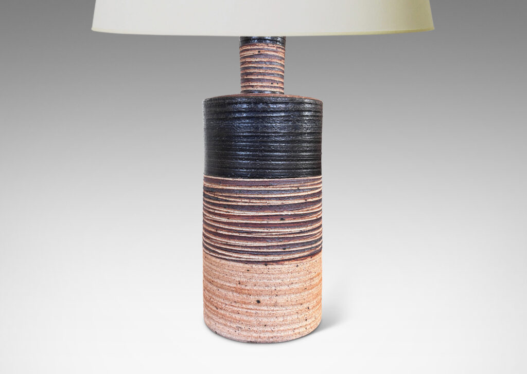 Gallery BAC slant-sided cylindrical forms with impressed texture and sprouting necks, glazed in shiny white and matte brown