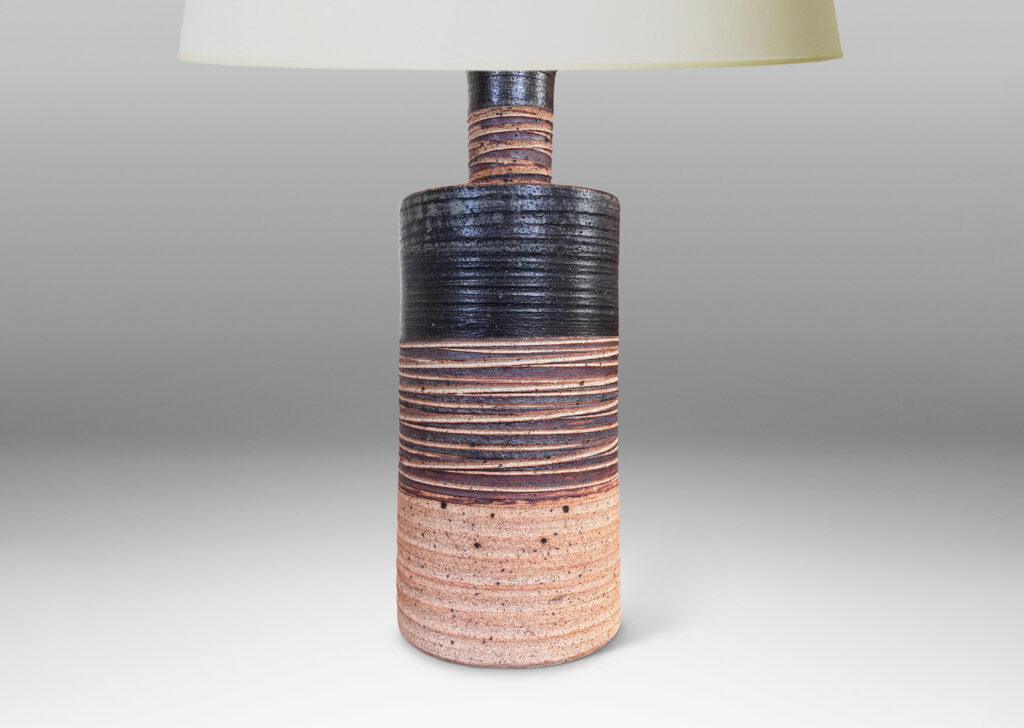 Gallery BAC slant-sided cylindrical forms with impressed texture and sprouting necks, glazed in shiny white and matte brown