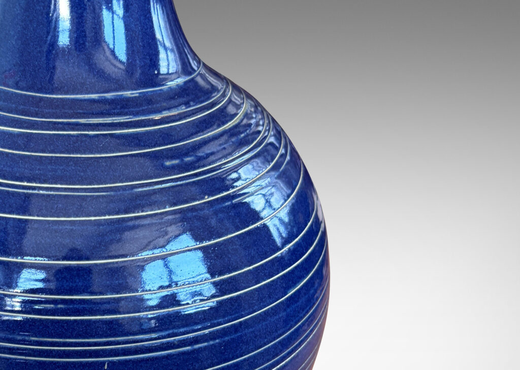 Gallery BAC globe body and tall neck, glazed in a deep blue with encircling sgraffito pinstripes