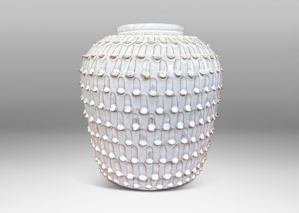 Gallery BAC wide, tapered form encircled in rows of carved strikes, glazed in glossy white