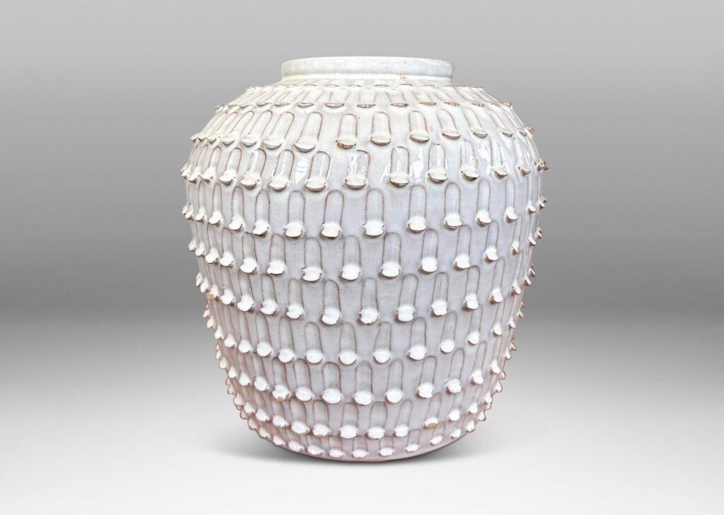 Gallery BAC wide, tapered form encircled in rows of carved strikes, glazed in glossy white