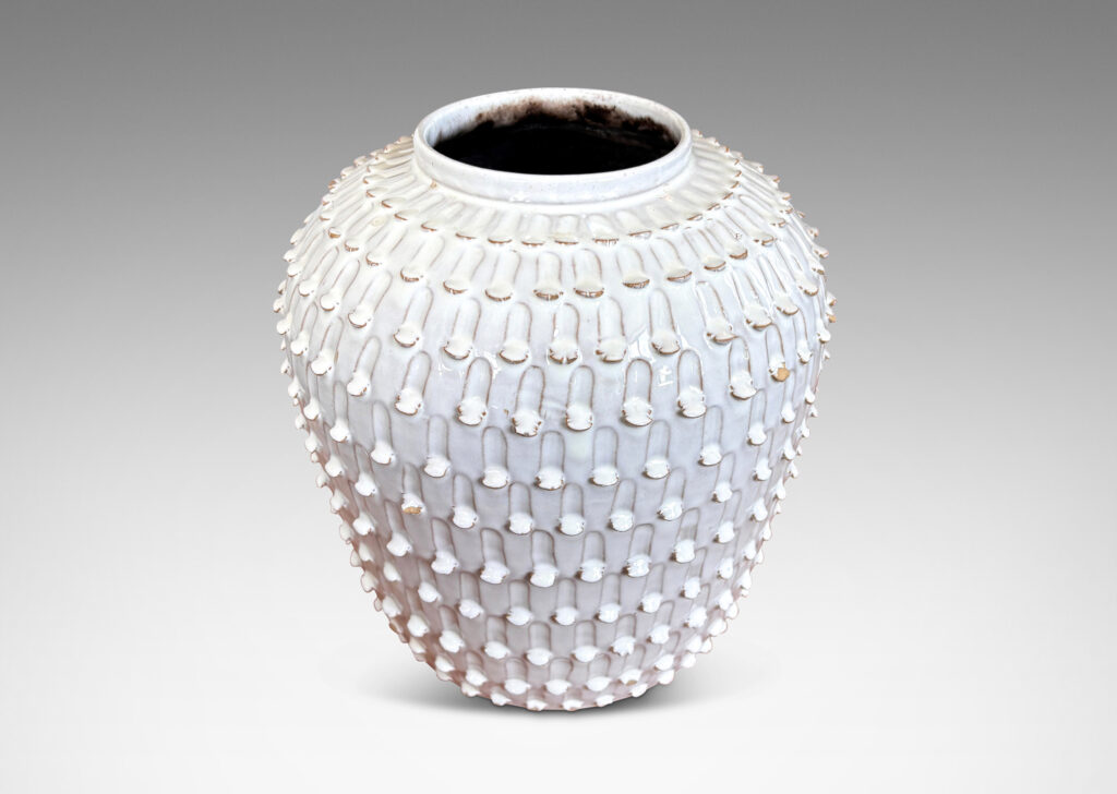 Gallery BAC wide, tapered form encircled in rows of carved strikes, glazed in glossy white