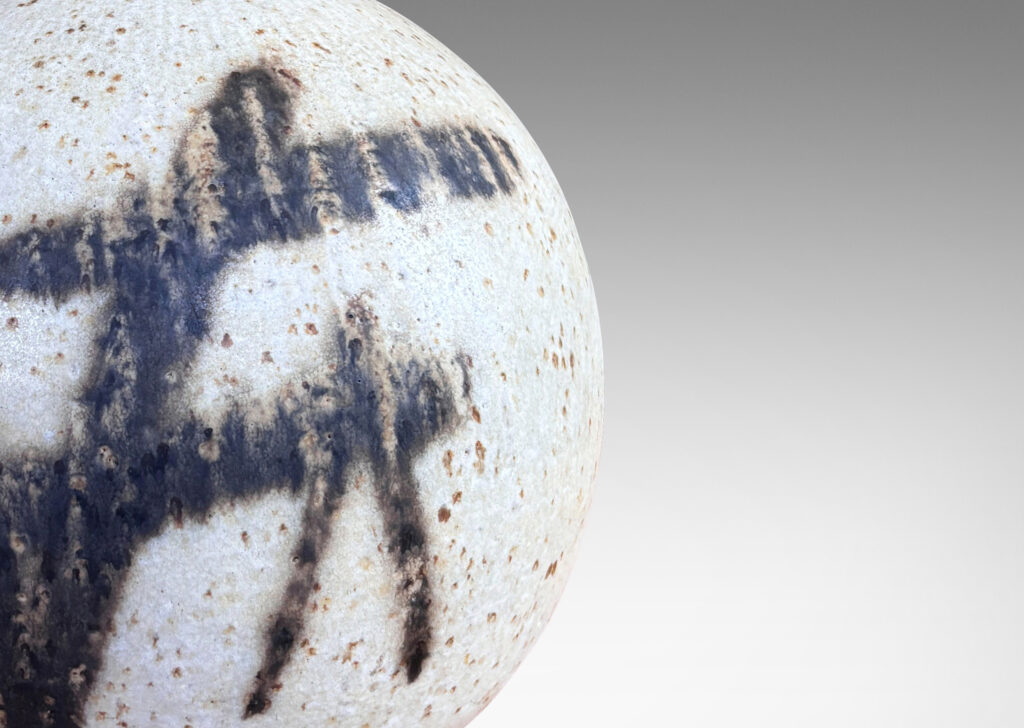 Gallery BAC globe form with slender neck, glazed in a matte speckled pale gray, with abstract design in dark brown