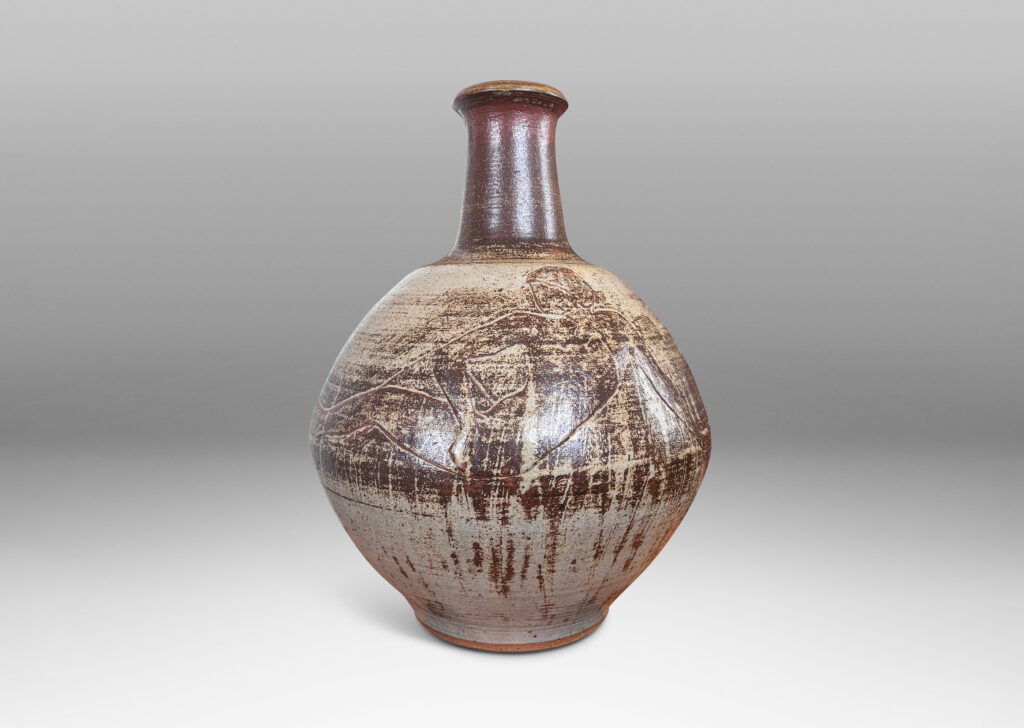 Gallery BAC angled globe form with reclining female figures in relief and tall neck, finished in a pale taupe and brown “Sung” glaze