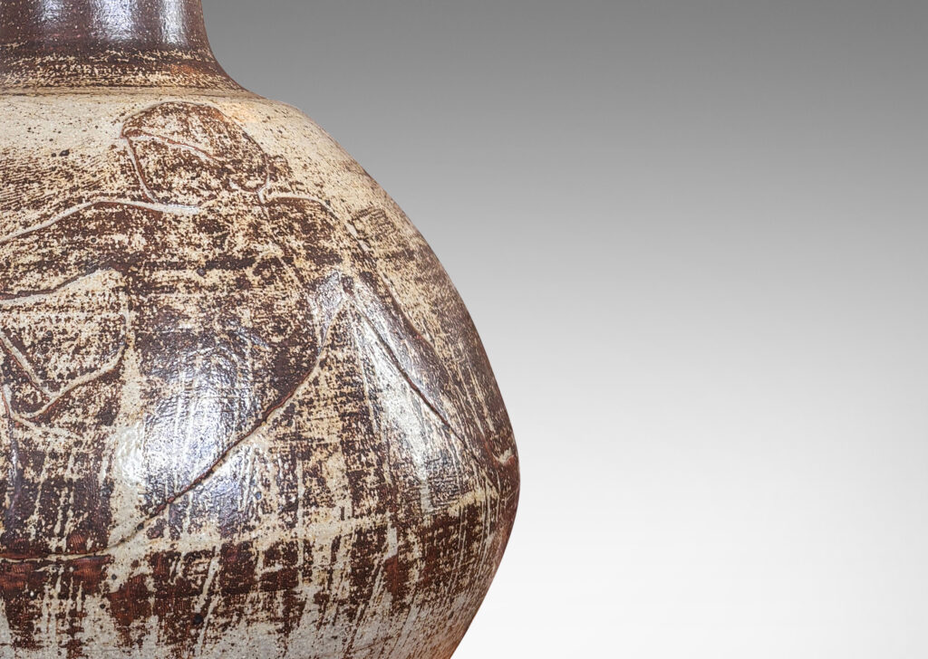 Gallery BAC angled globe form with reclining female figures in relief and tall neck, finished in a pale taupe and brown “Sung” glaze