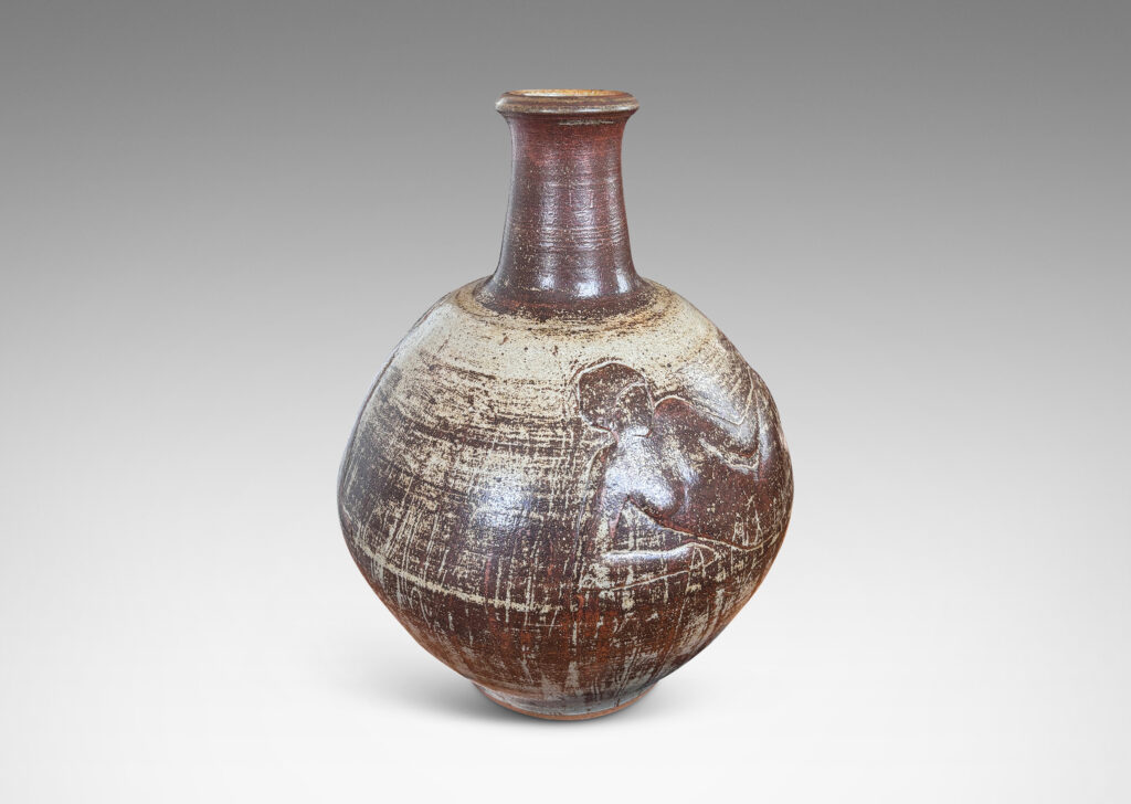 Gallery BAC angled globe form with reclining female figures in relief and tall neck, finished in a pale taupe and brown “Sung” glaze