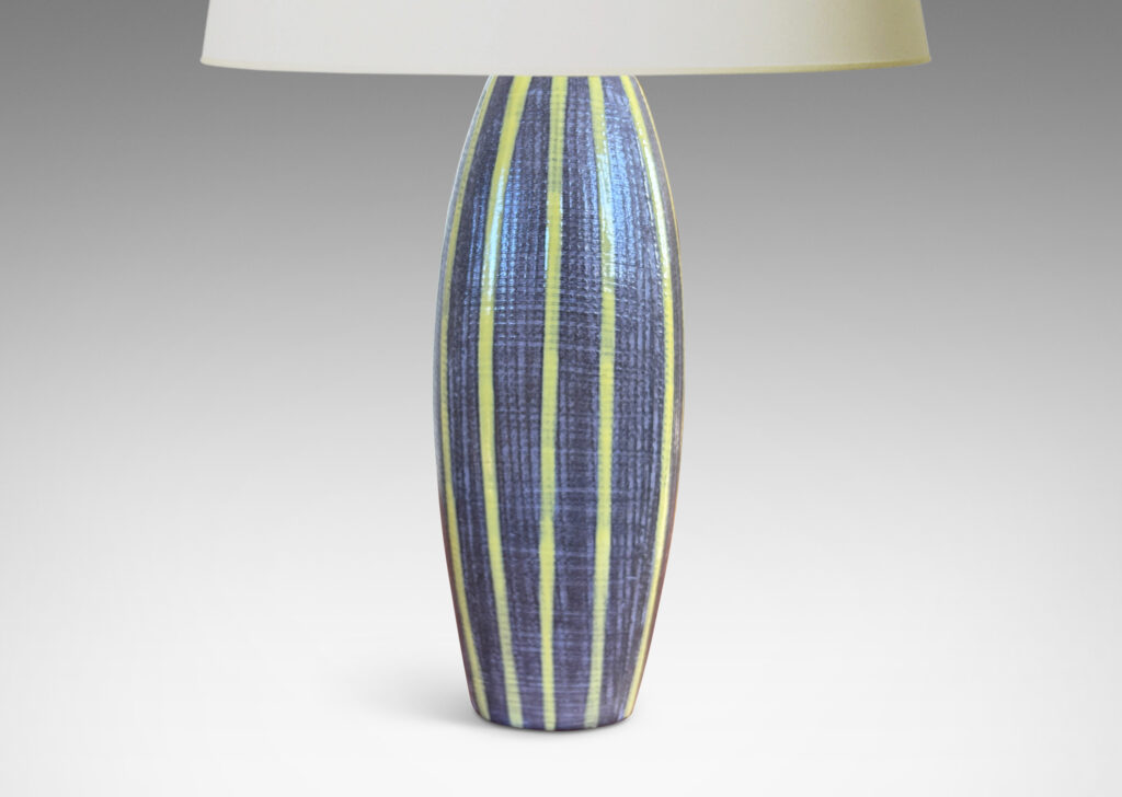 Gallery BAC swelling squared form with raked surface texture, glazed in a medium gray with yellow vertical pinstripes