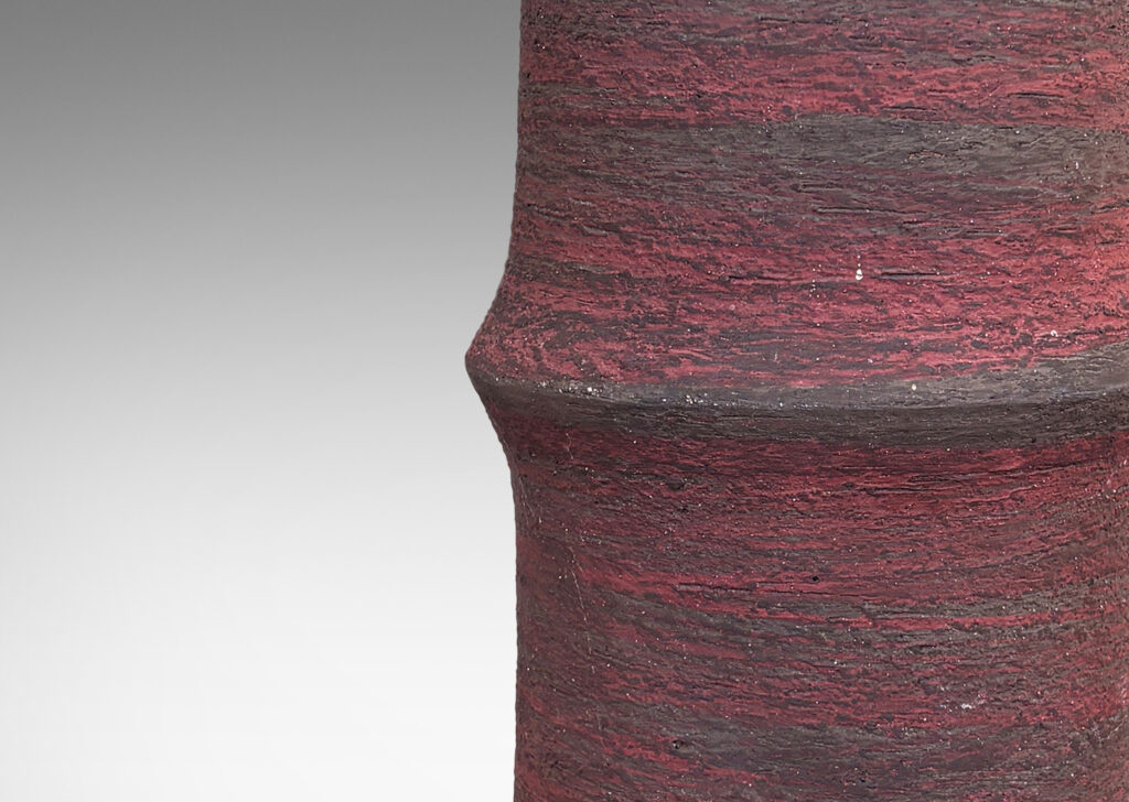 Gallery BAC cylindrical form with bamboo-like notch detail, glazed in matte brick red and brown, with an eggshell pale taupe interior
