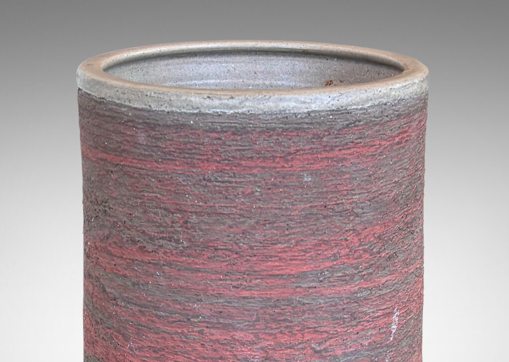 Gallery BAC cylindrical form with bamboo-like notch detail, glazed in matte brick red and brown, with an eggshell pale taupe interior
