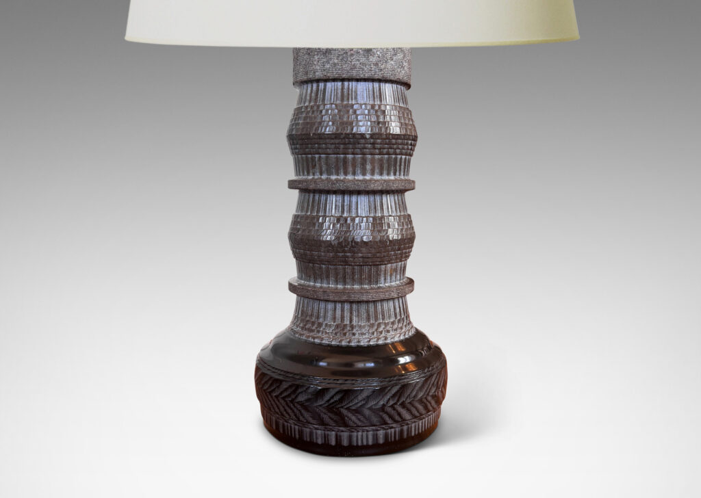 Gallery BAC totemic pillar form with turned and carved ornamental textures in a matte gray, with gloss black