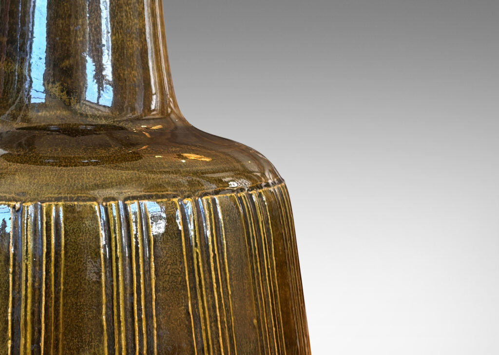 Gallery BAC angled drum form with carved vertical stripes and wide neck, glazed in yellow/gray