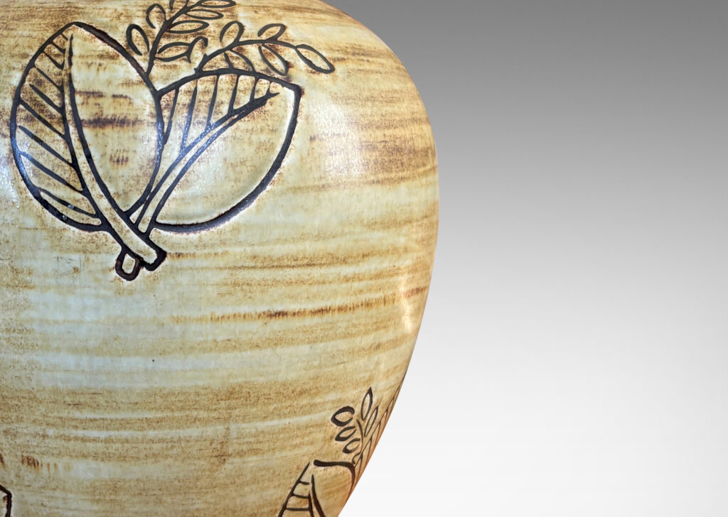 Gallery BAC traditional tapering form with plinth base and carved leafy motifs, glazed in a woodgrain-evoking matte striae brown over gold