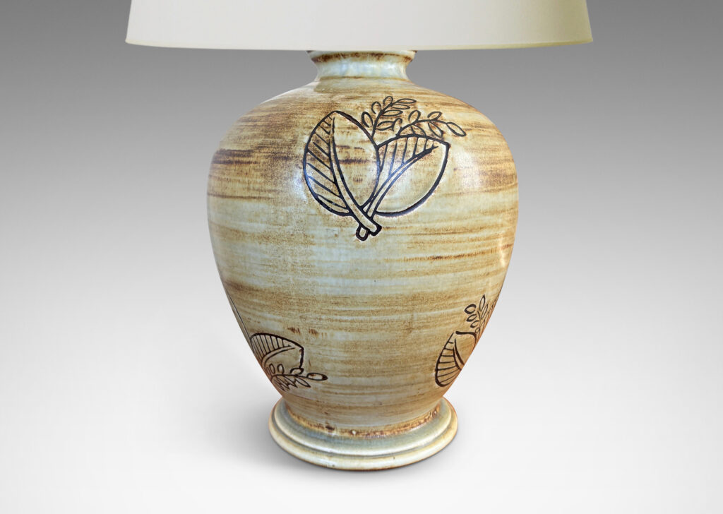 Gallery BAC traditional tapering form with plinth base and carved leafy motifs, glazed in a woodgrain-evoking matte striae brown over gold