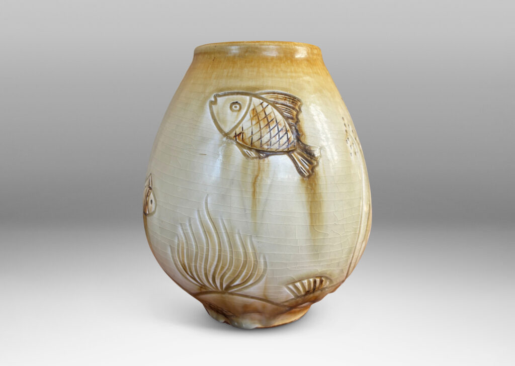 Gallery BAC tulip form with carved reliefs of goldfish and water flora, glazed in a thin amber-tan with brown accents