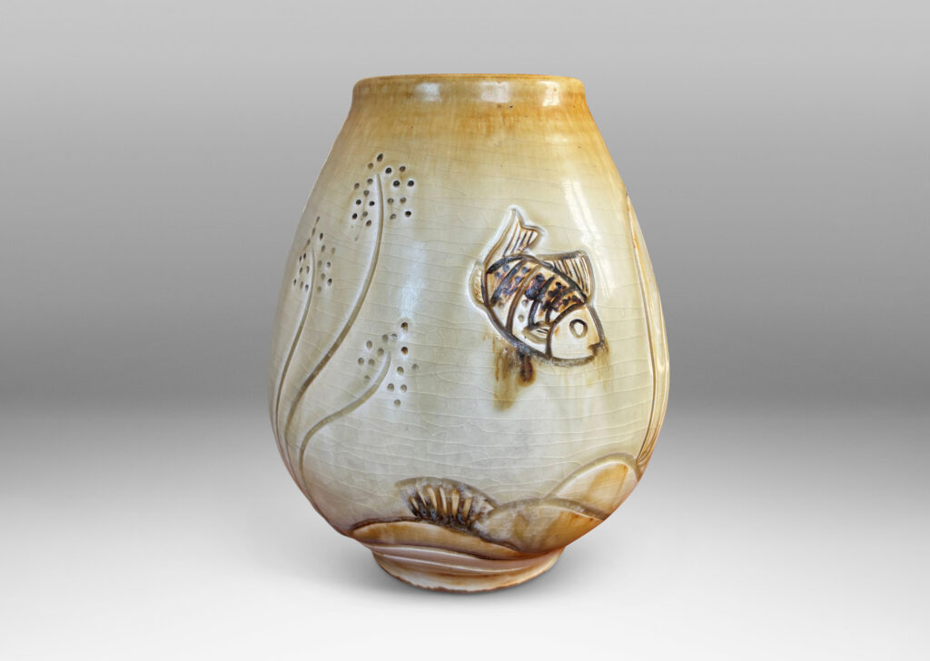 Gallery BAC tulip form with carved reliefs of goldfish and water flora, glazed in a thin amber-tan with brown accents