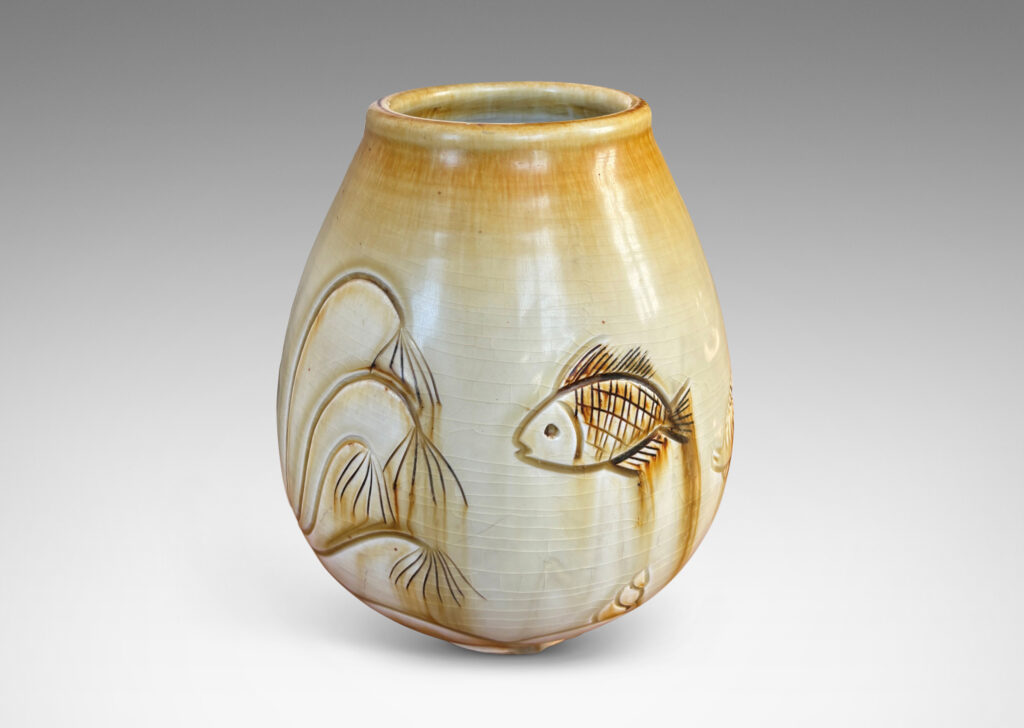 Gallery BAC tulip form with carved reliefs of goldfish and water flora, glazed in a thin amber-tan with brown accents