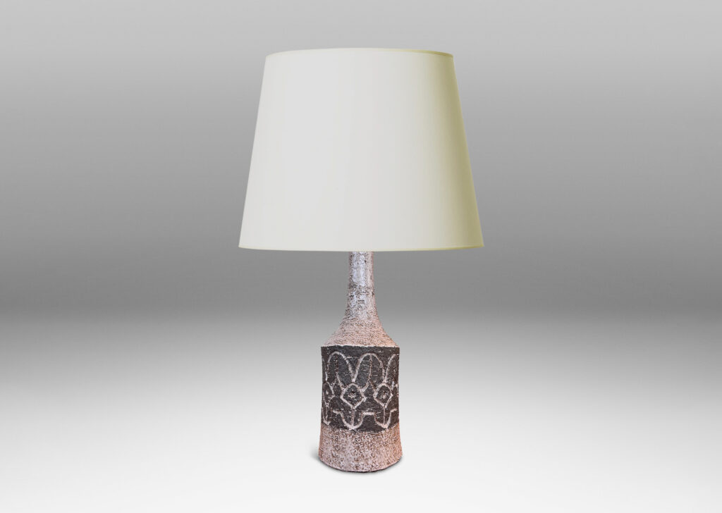 Gallery BAC bow-sided cylindrical form with carved abstract floral design and sprouting neck, glazed in pale taupe-gray and dark brown