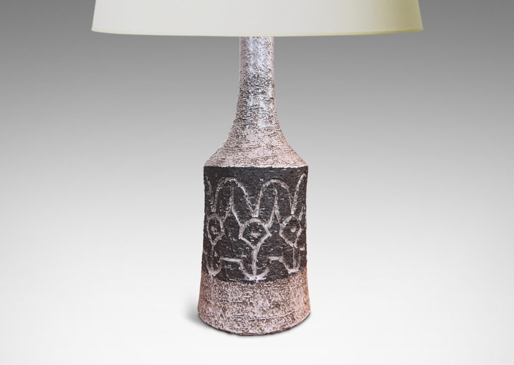 Gallery BAC bow-sided cylindrical form with carved abstract floral design and sprouting neck, glazed in pale taupe-gray and dark brown