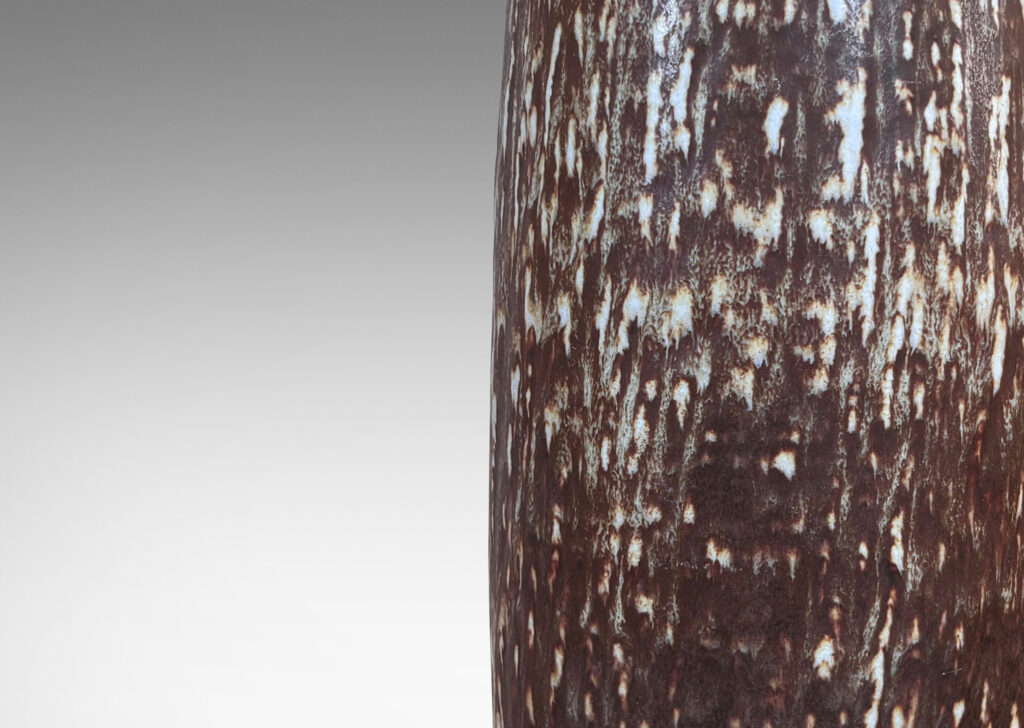 Gallery BAC swelling form with carved texture glazed in a running dark brown