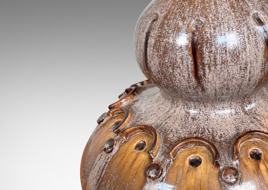 Gallery BAC dramatic double gourd form punctuated with impressed and relief geometric motifs, glazed in mocha brown with pale puce-taupe