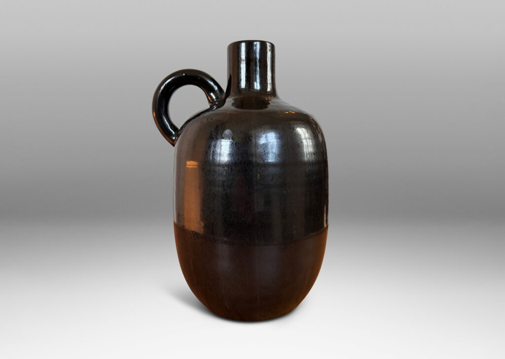 Gallery BAC upright ovoid form with carved pinstripe meridians, spouting neck, and arced handle