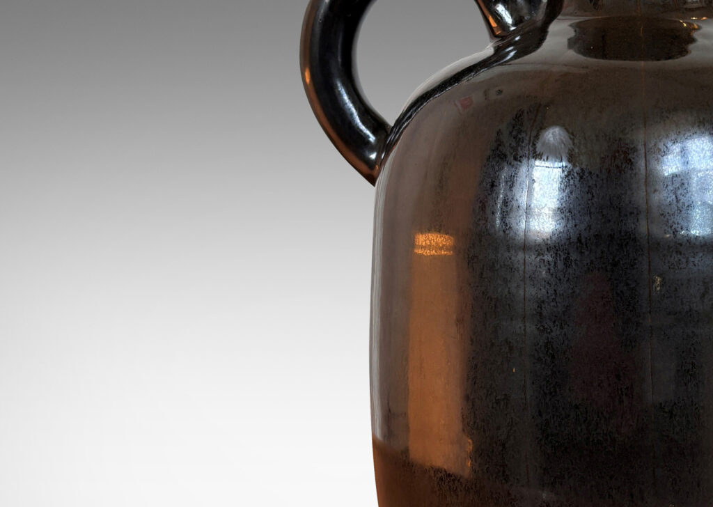 Gallery BAC upright ovoid form with carved pinstripe meridians, spouting neck, and arced handle