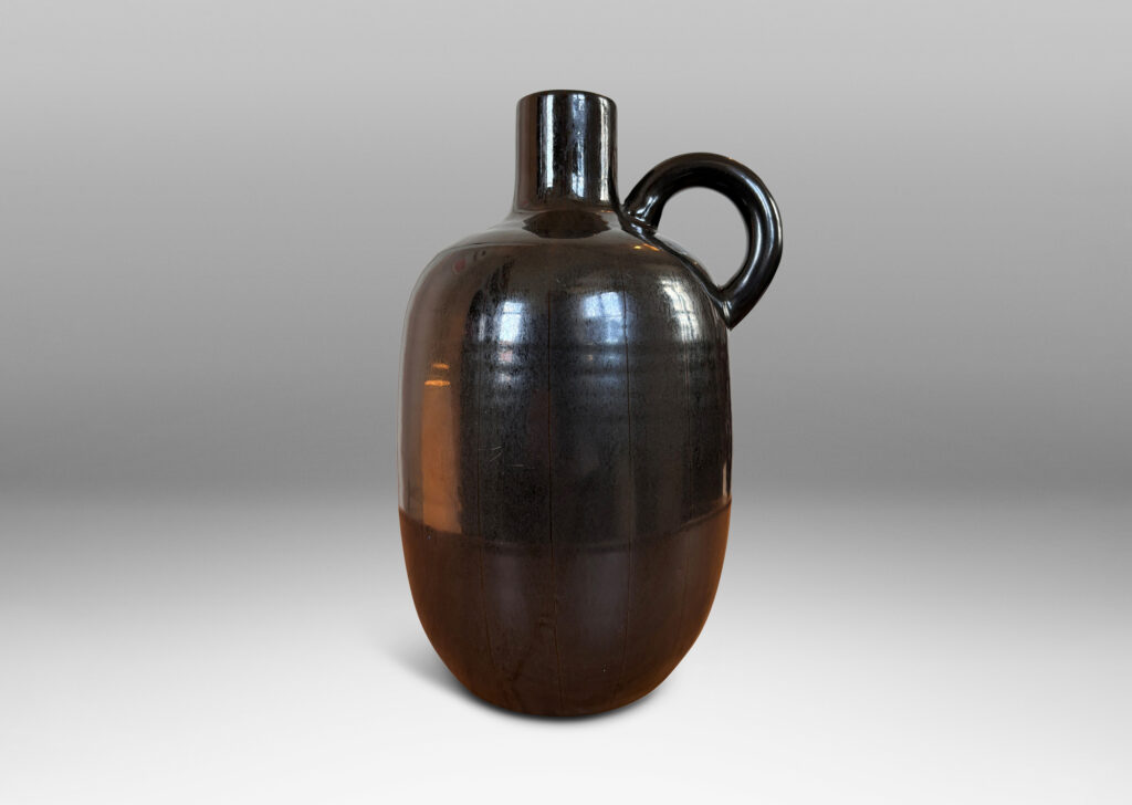 Gallery BAC upright ovoid form with carved pinstripe meridians, spouting neck, and arced handle