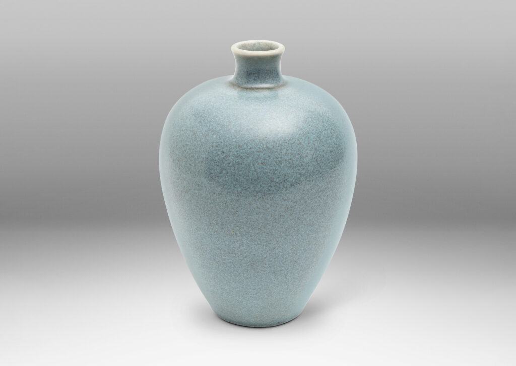 Gallery BAC tapered form with spouting mouth, glazed in a speckled light blue glaze