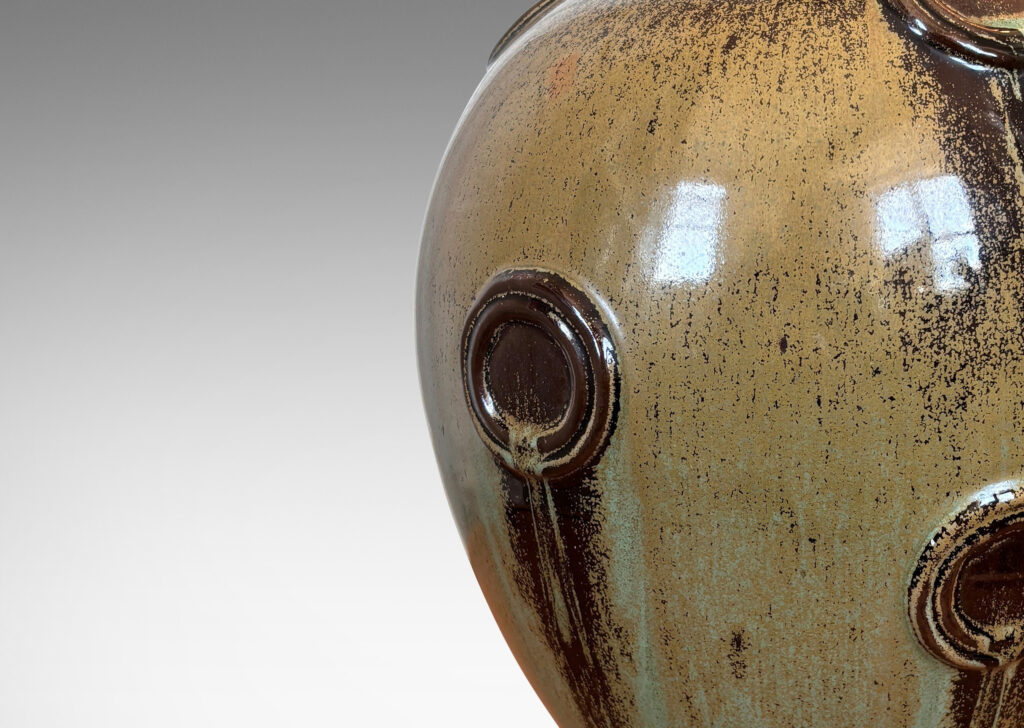 Gallery BAC balloon form with floating circular motifs in relief, glazed in olive green and brown tones