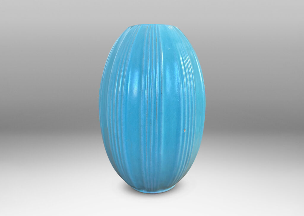 Gallery BAC upright pointed ovoid form, with vertical ribbing in relief, glazed in a soft blue-tinged celadon green